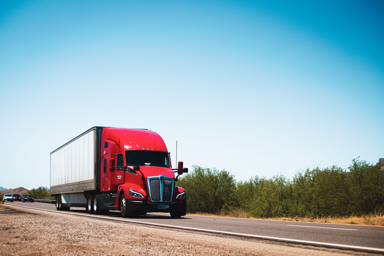Red freight truck on a highway